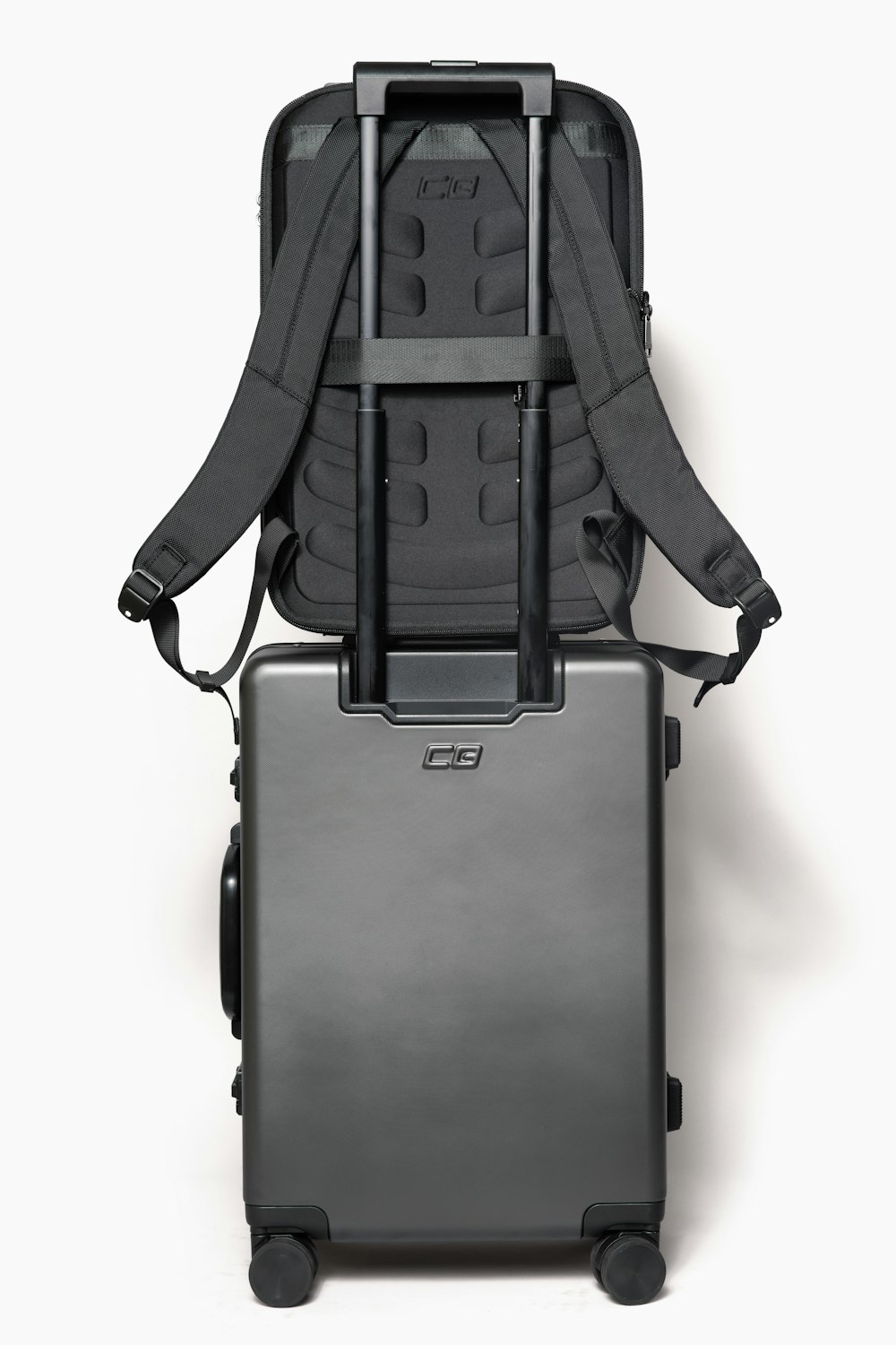 the back of a suitcase with wheels and a backpack attached to it