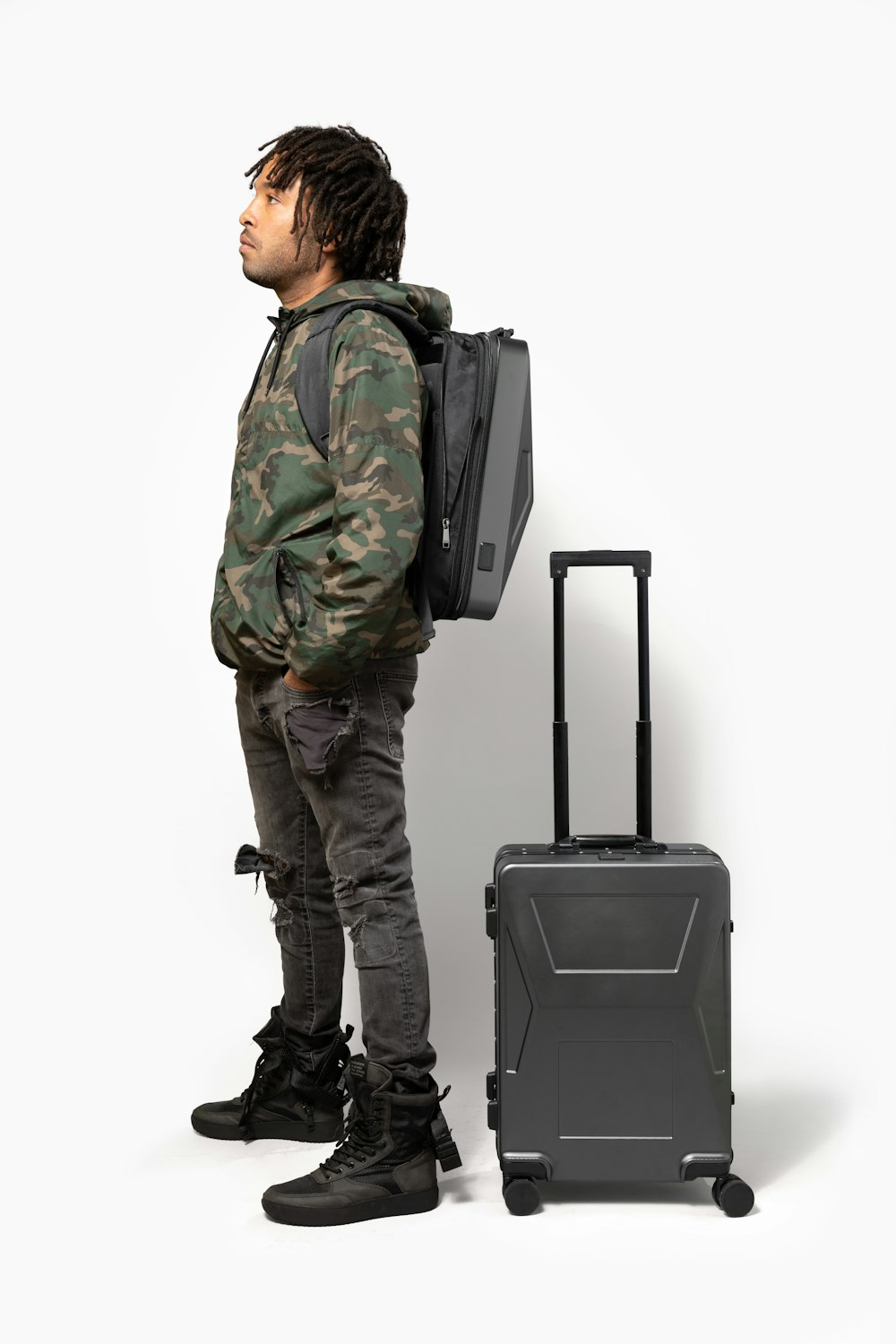 a man with a backpack and a suitcase
