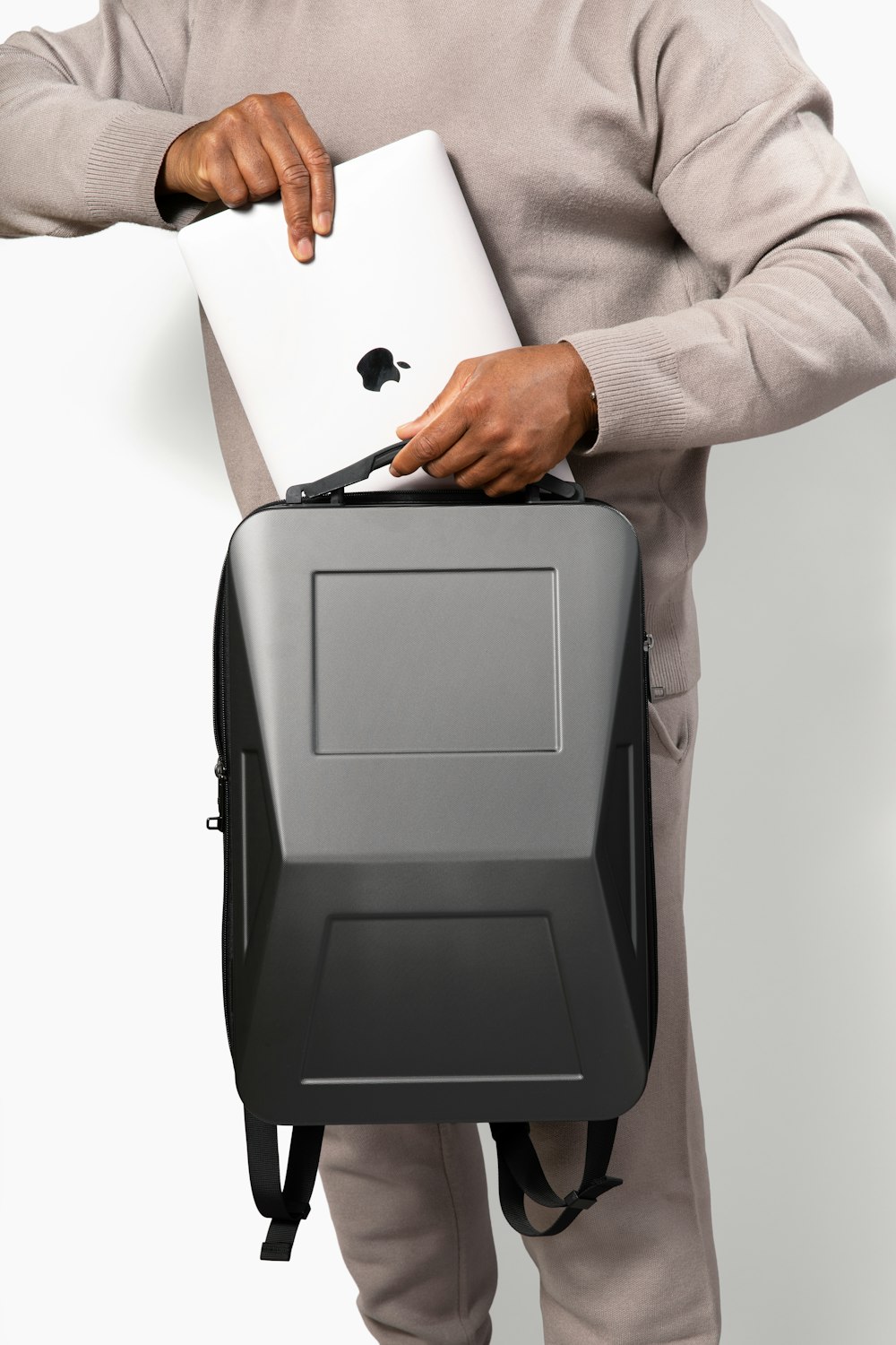 a man holding a laptop and a briefcase