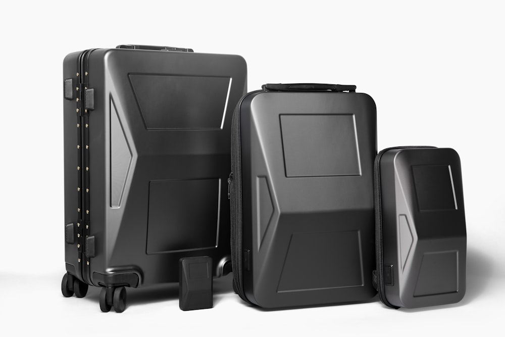 three pieces of black luggage sitting next to each other