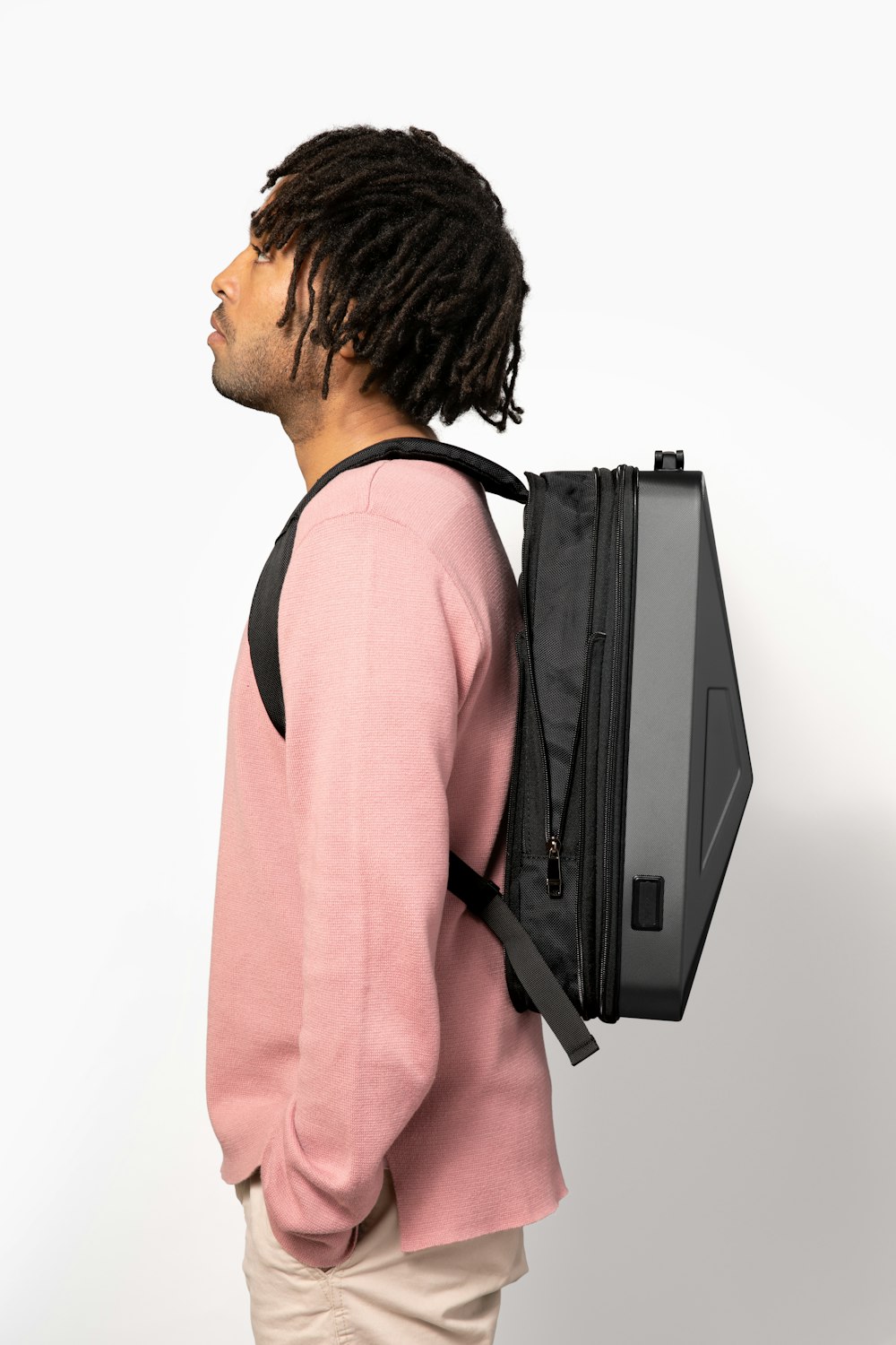 a man with dreadlocks wearing a backpack