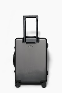 A sleek babeker suitcase standing upright against a neutral background, showcasing its scratch-resistant fabric and sturdy hardware.