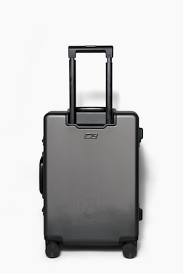 A sleek black suitcase with expandable compartments open on a wooden floor.