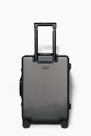 A stylish pink travel suitcase with a sleek design on a white background.