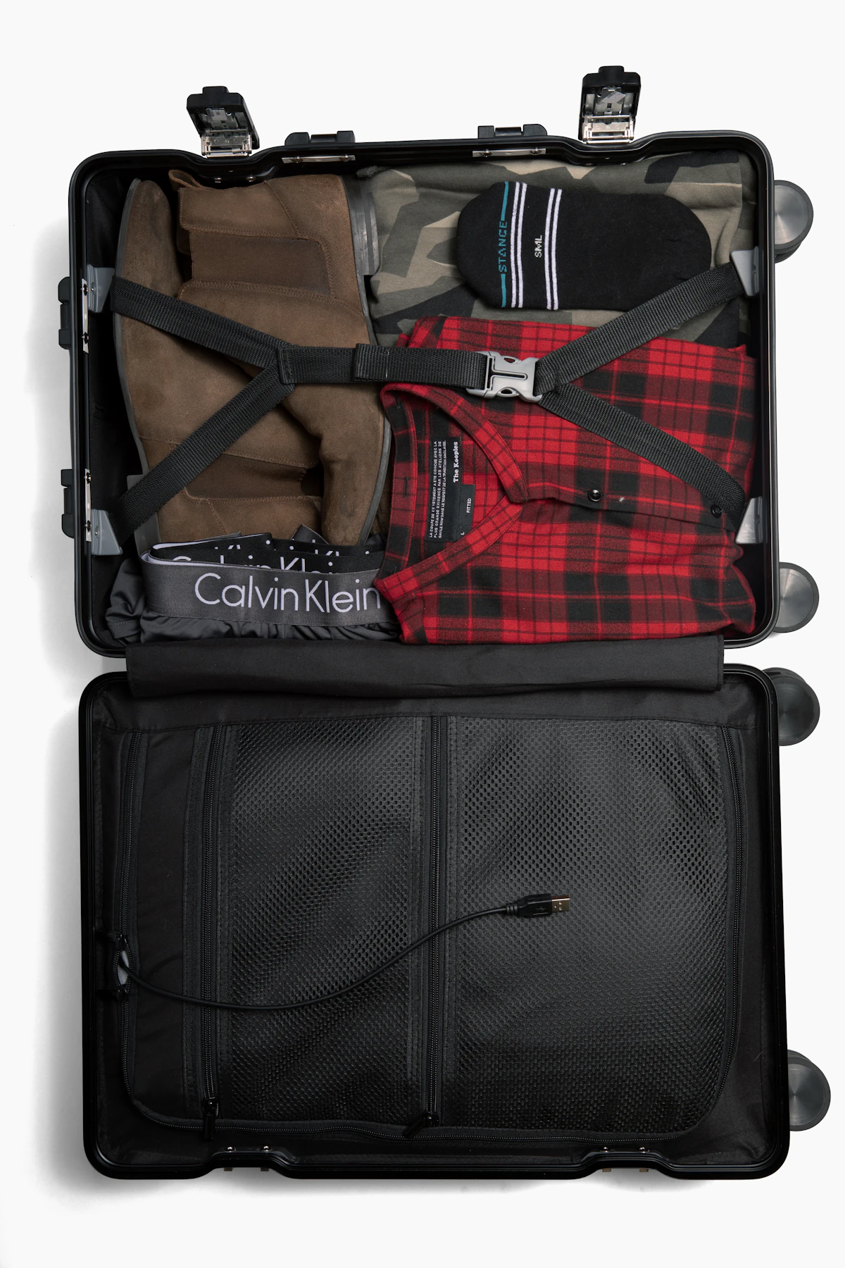 Open suitcase packed for travel with neatly organized clothing