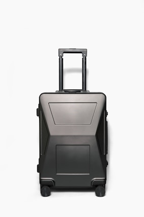 A sleek, lightweight suitcase with an aluminum frame and scratch-resistant surface standing upright on a smooth floor.
