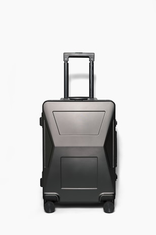 The structured design of a phere llc suitcase resisting deformation while being placed in an overhead airplane compartment.