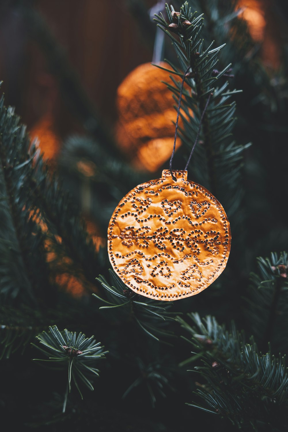 a wooden ornament hanging from a christmas tree