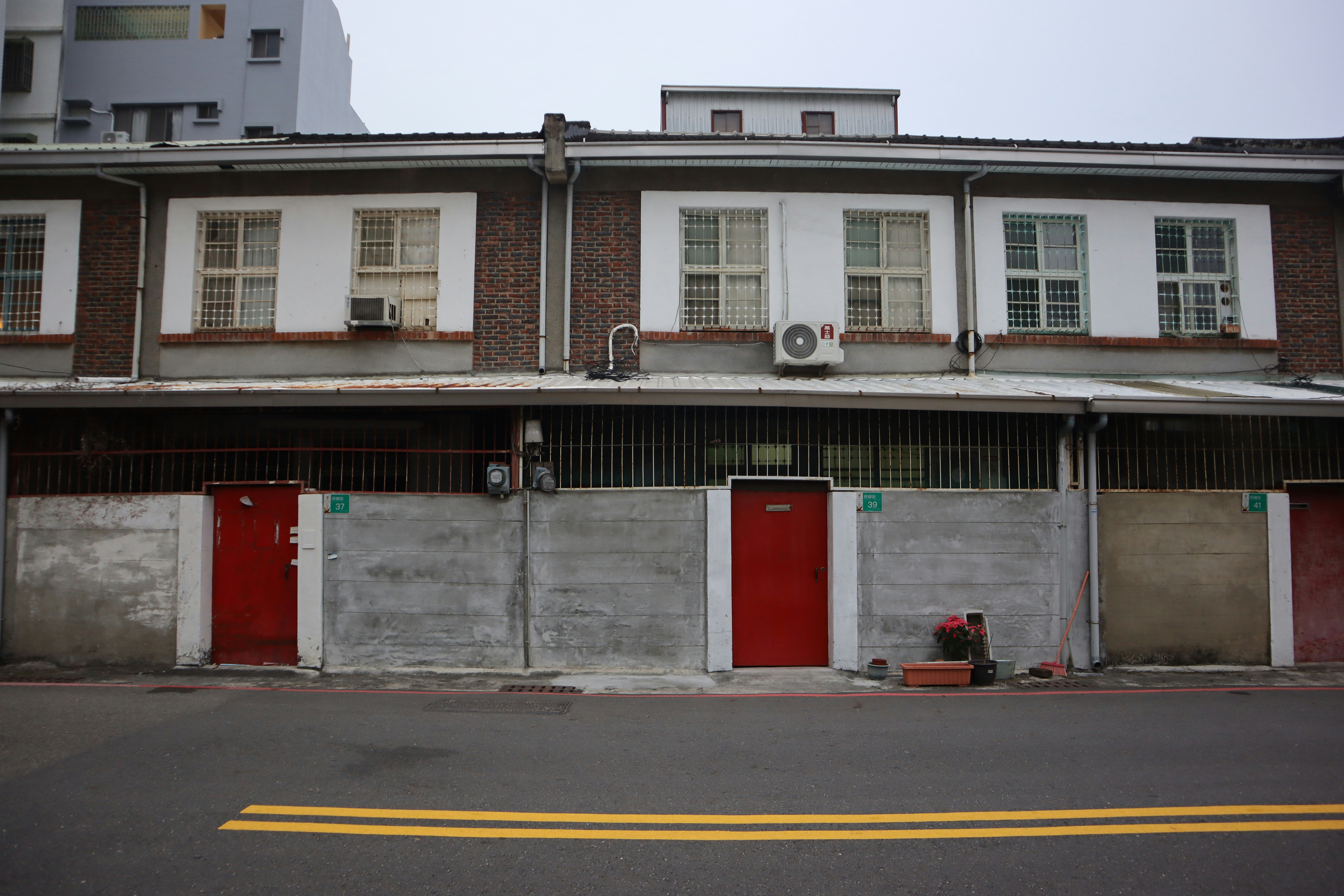 a row of buildings with red doors and windows