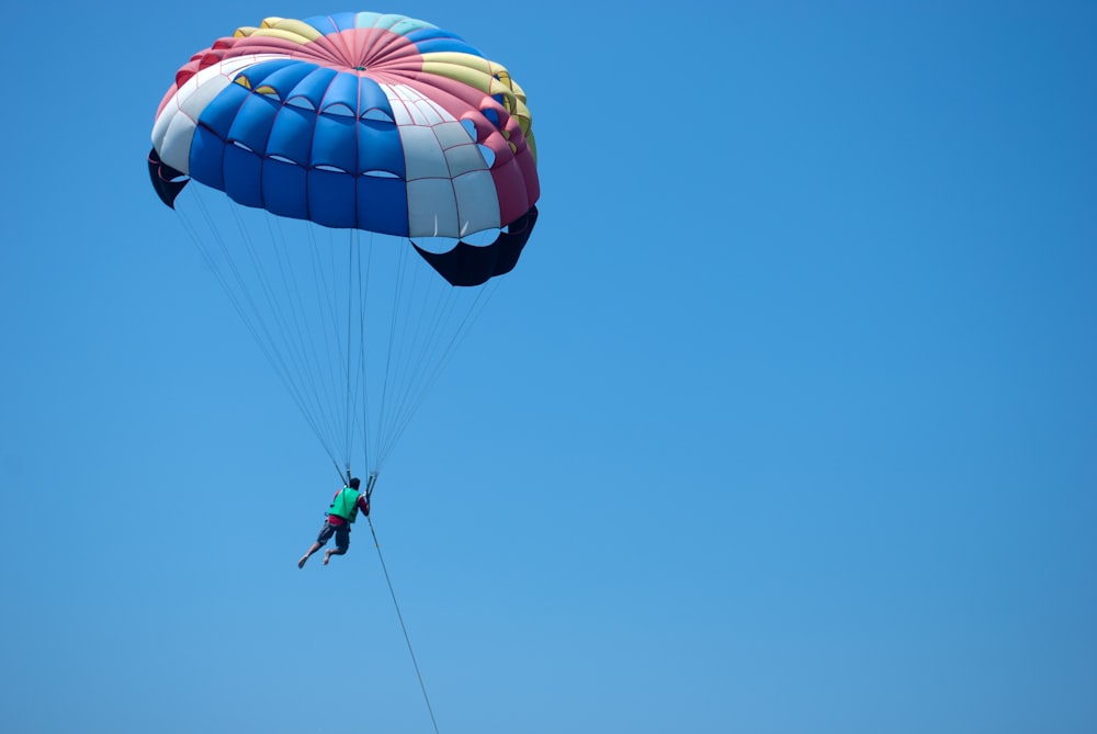 a person is parasailing high in the sky