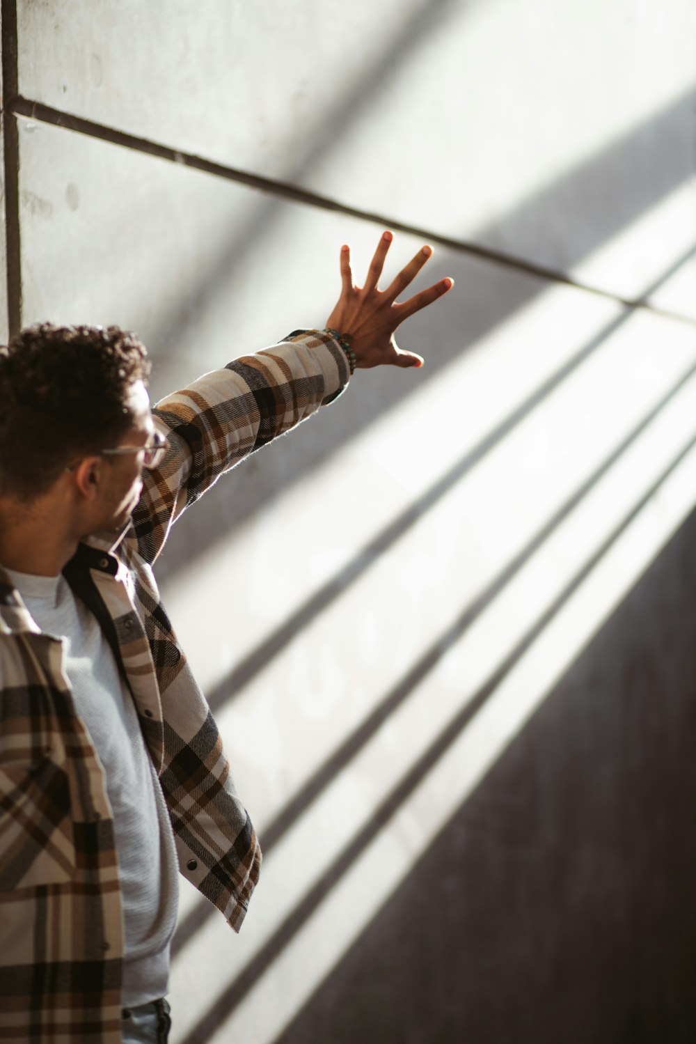 a man standing in front of a wall with his arms outstretched