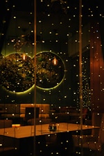 A warmly lit room set up for an intimate private party with string lights and rustic decor.