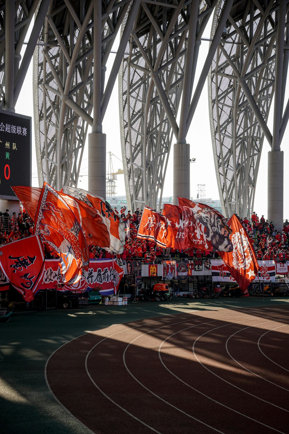 a stadium full of red flags and banners