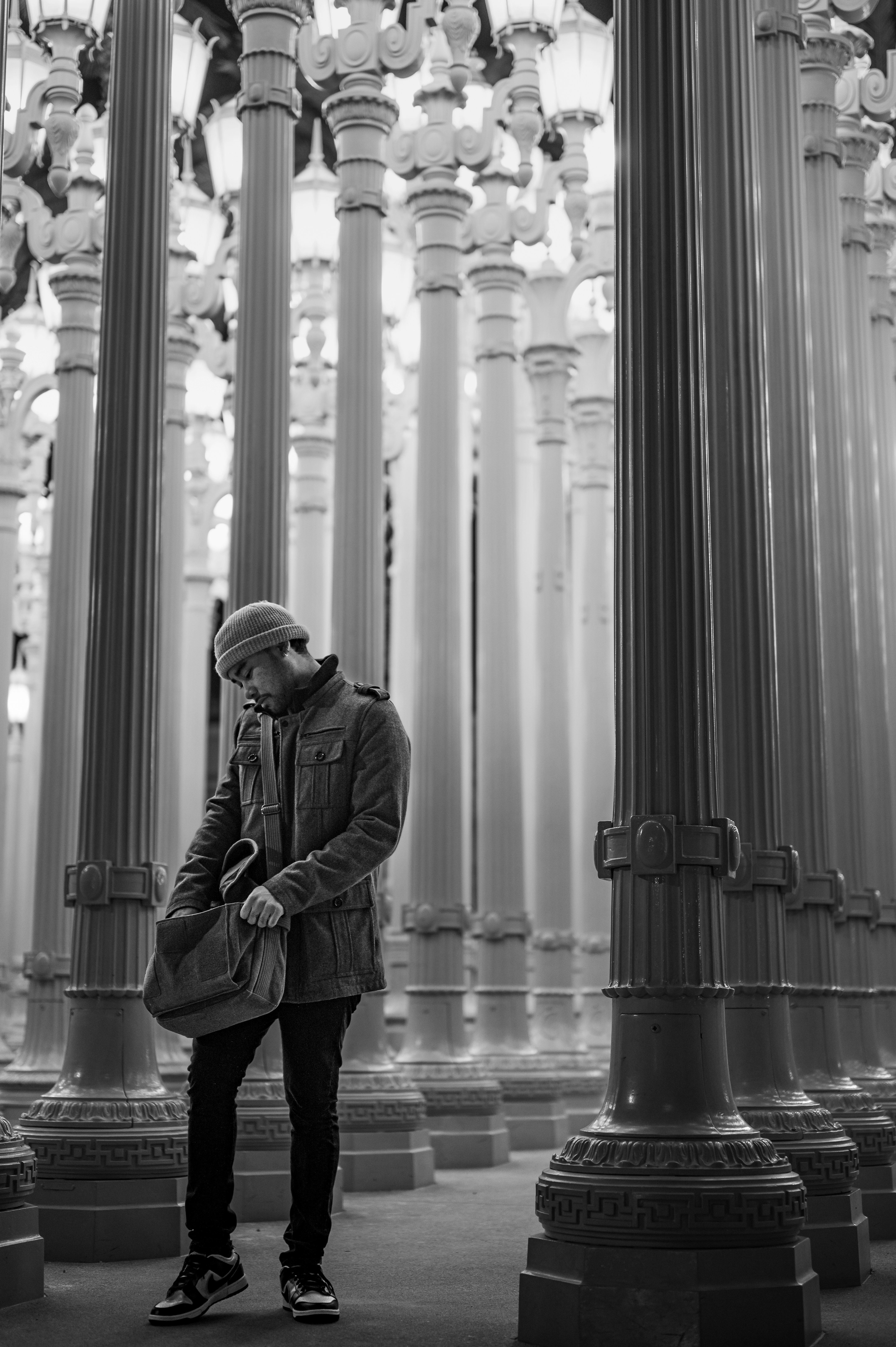 a man standing in front of a large chandelier