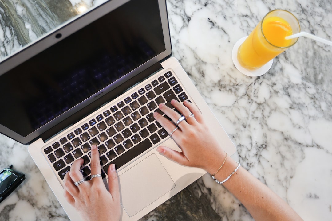 a woman using a laptop computer on a marble table, Turn it on
