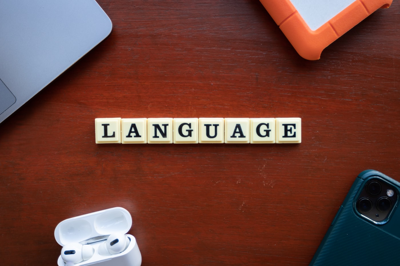 The word language spelled out with scrabble tiles