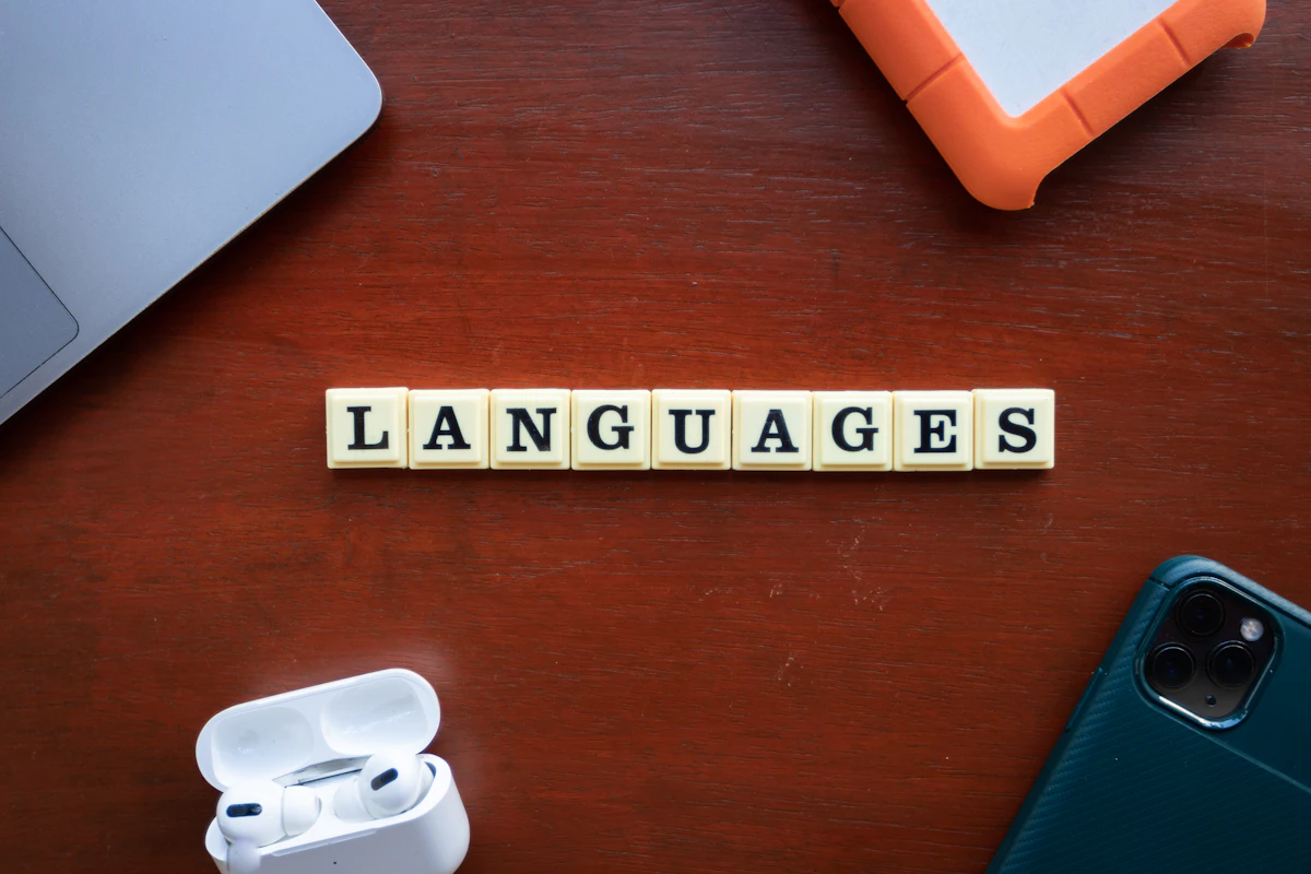 Wooden blocks spelling out languages, representing French exam preparation for TCF Canada