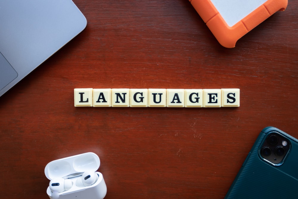 a close up of a wooden block that says languages