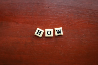 the word wow spelled with scrabble letters on a wooden surface