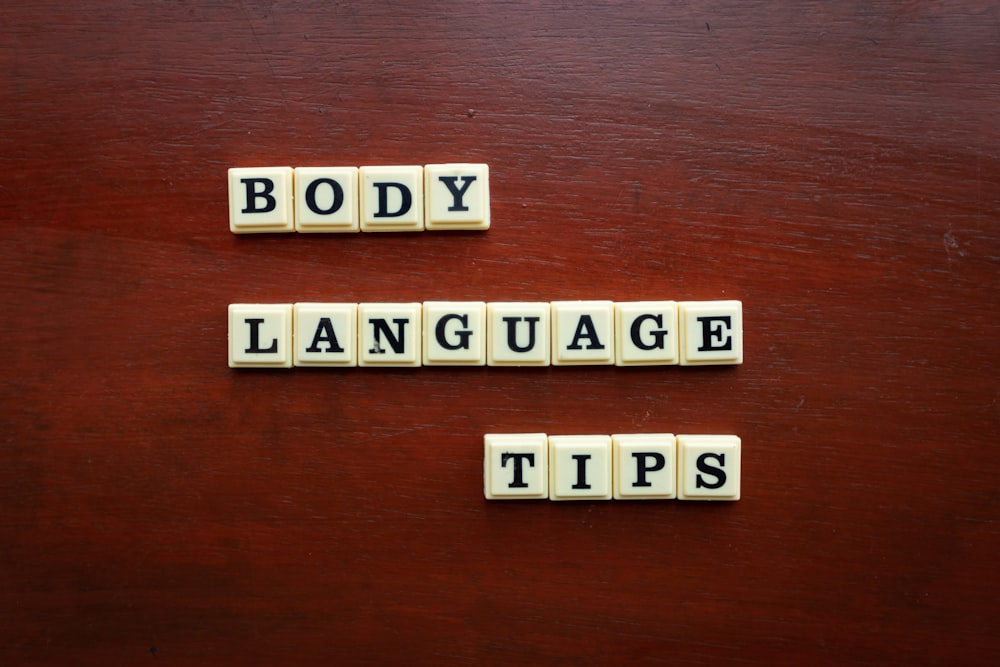 two scrabble tiles spelling body language tips