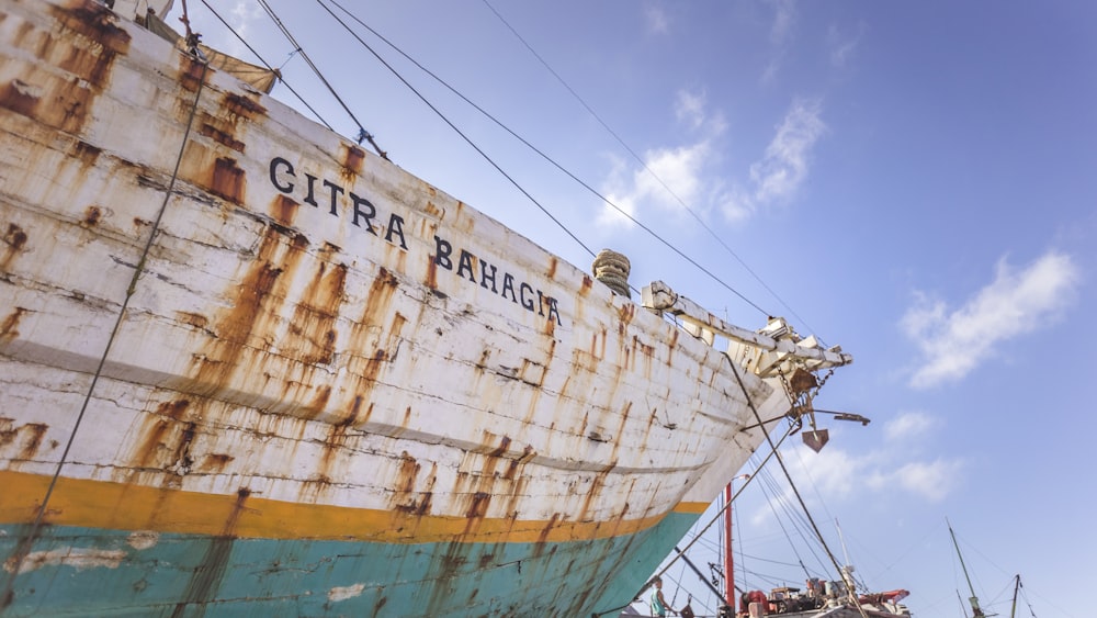 an old rusted boat sitting on top of a dry dock