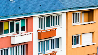 a multicolored building with windows and balconies