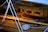 An interior of a wooden boat featuring polished wooden surfaces and multiple ropes coiled neatly. The cabin walls have a warm, honey-colored finish with a few rectangular panels. Slight reflections hint at a glossy sheen on the wood.
