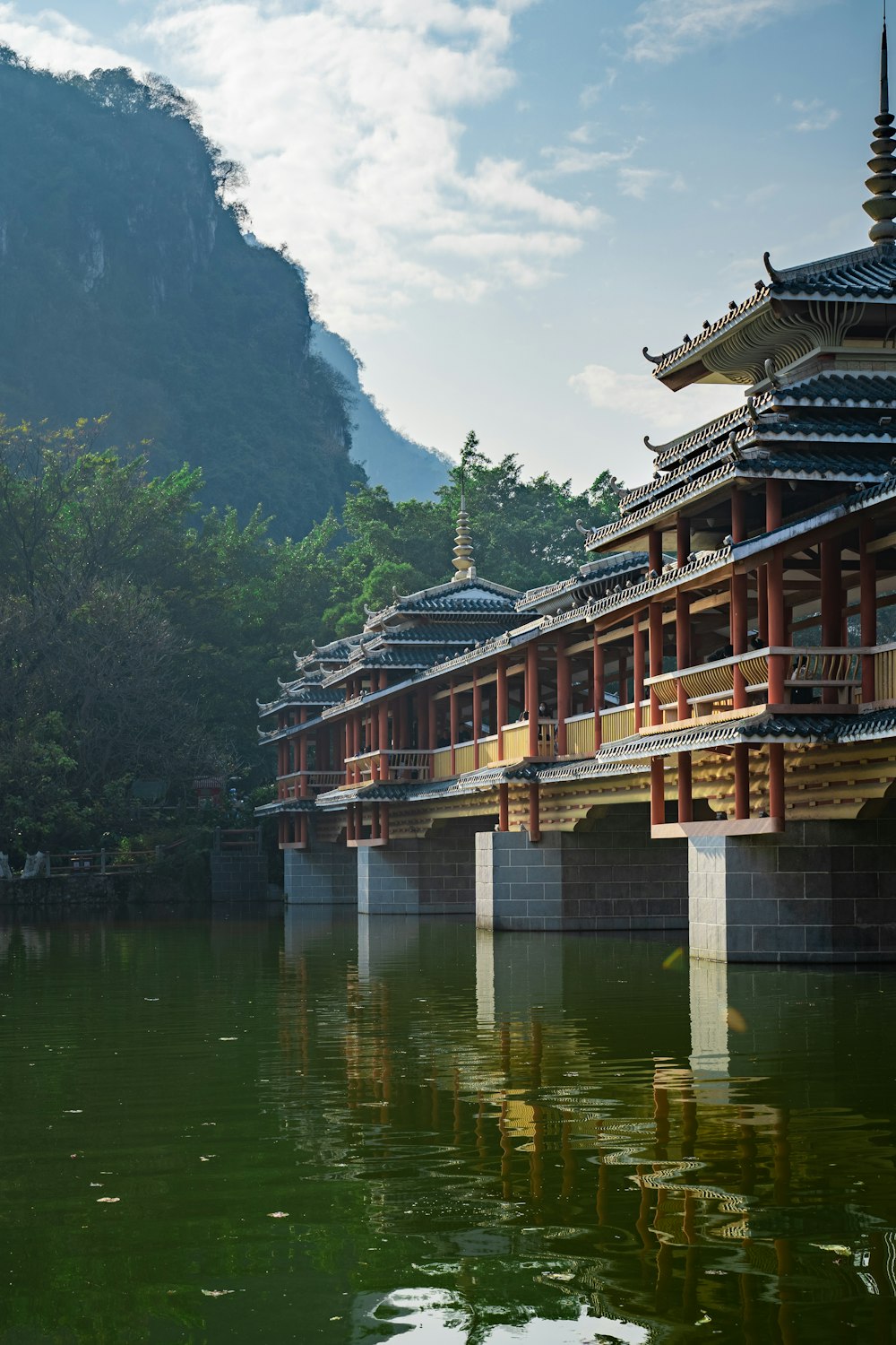 a bridge over a body of water with a building in the background