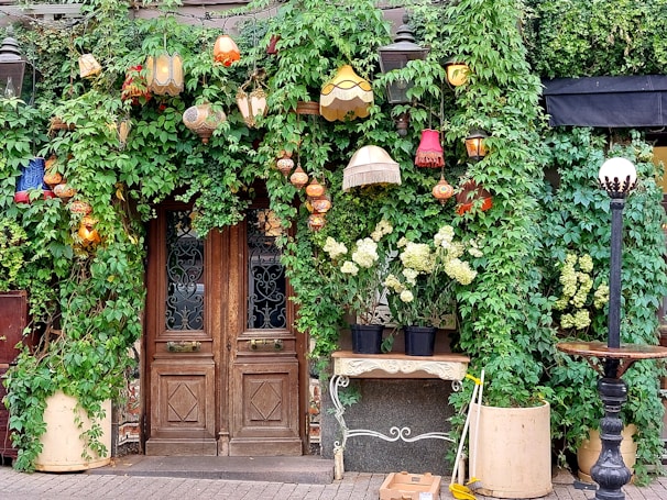 A welcoming hotel entrance decorated with lanterns and greenery.