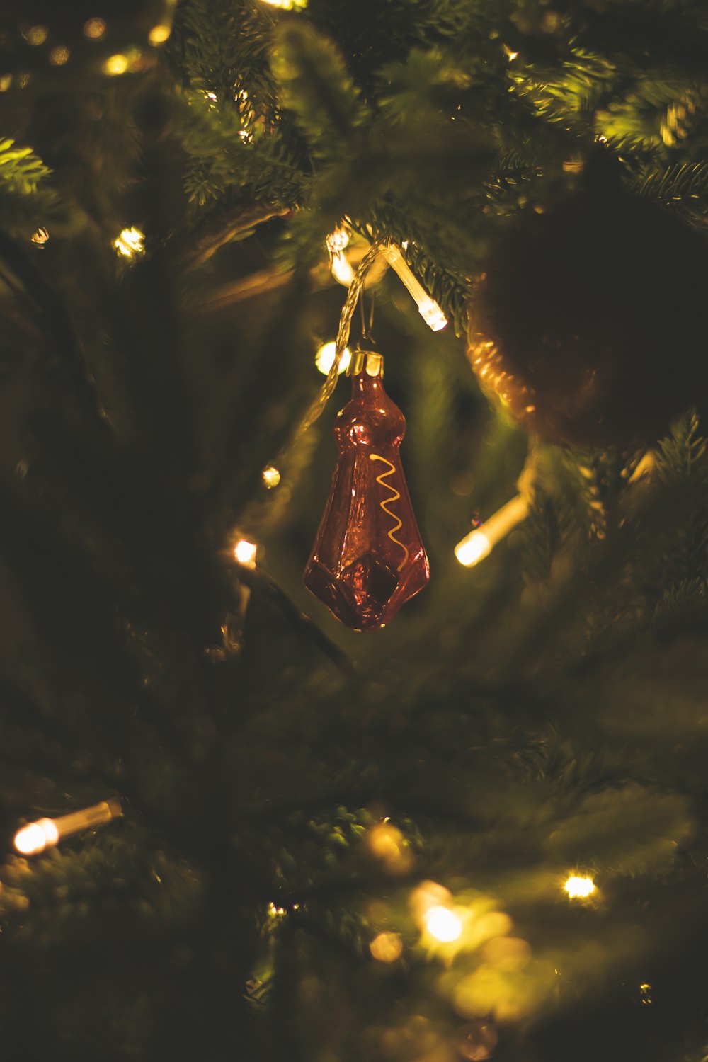 a christmas ornament hanging from a christmas tree