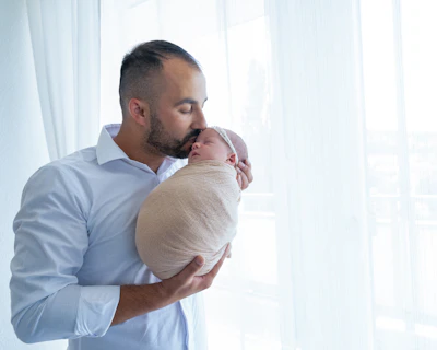 a man holding a baby in his arms