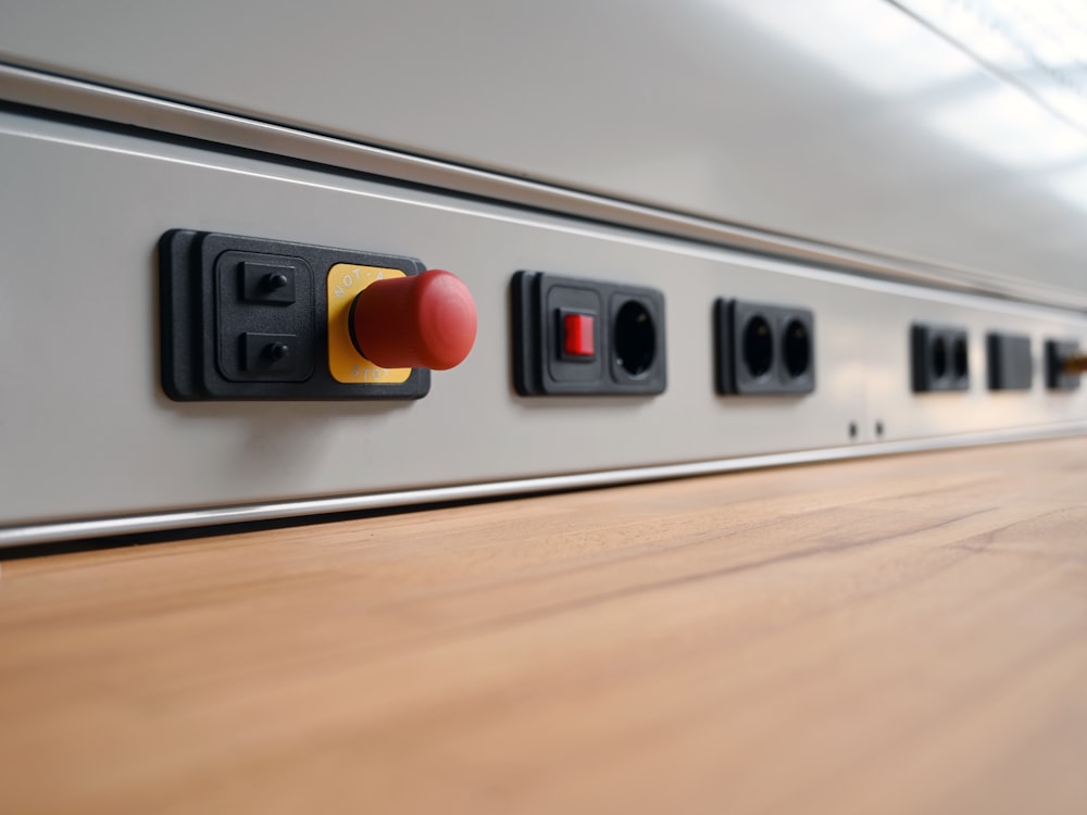 a close up of a switch box on a wooden floor