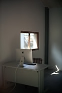 Bright workspace featuring minimalist desk and organized shelves.