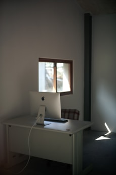 Clean, elegant workspace with natural light highlighting minimalist design and premium materials.