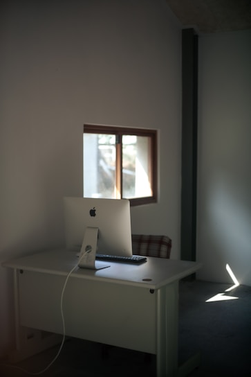 A minimalist workspace featuring a sleek desk and modern decor.