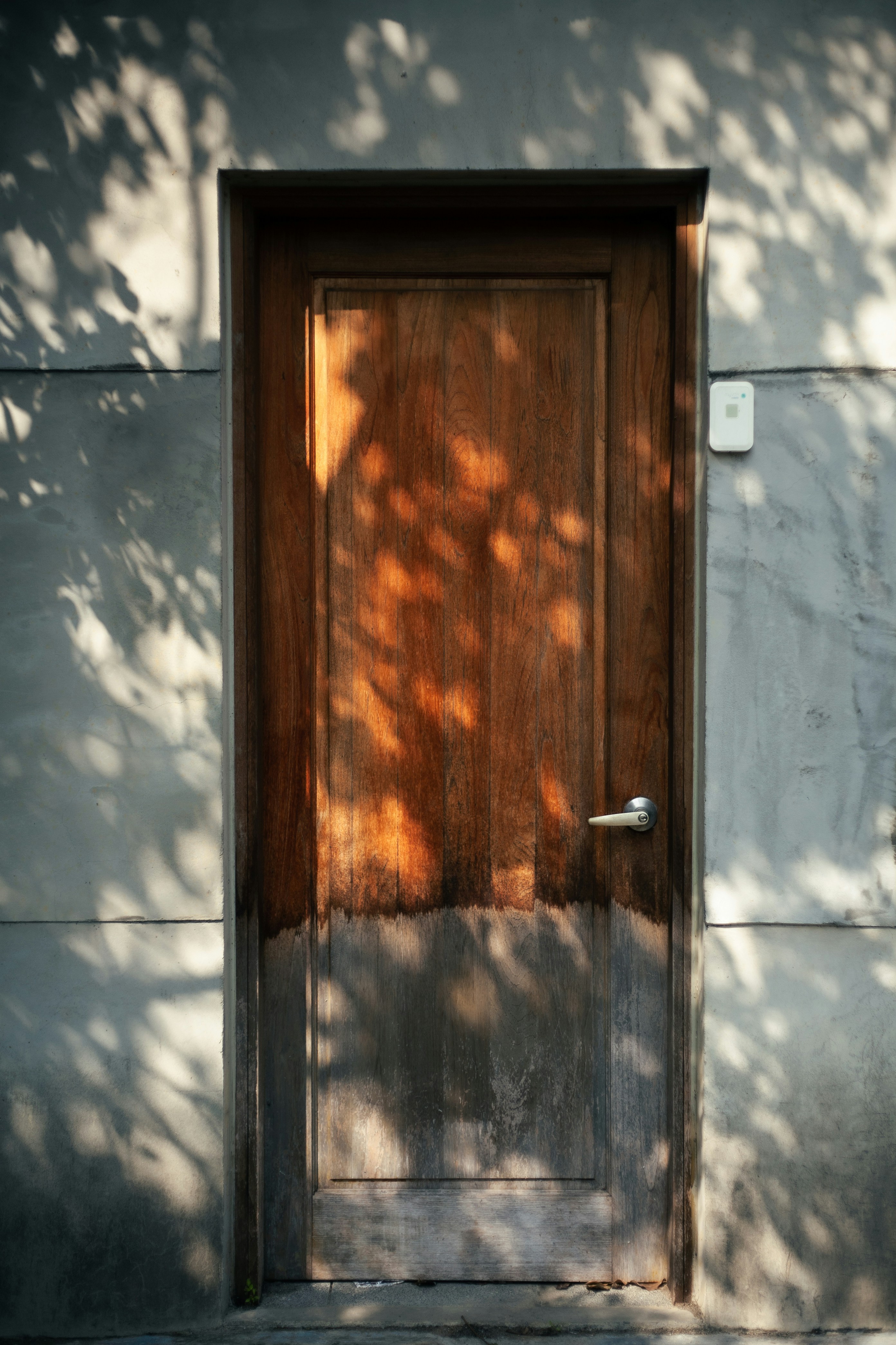 a wooden door with a light shining on it