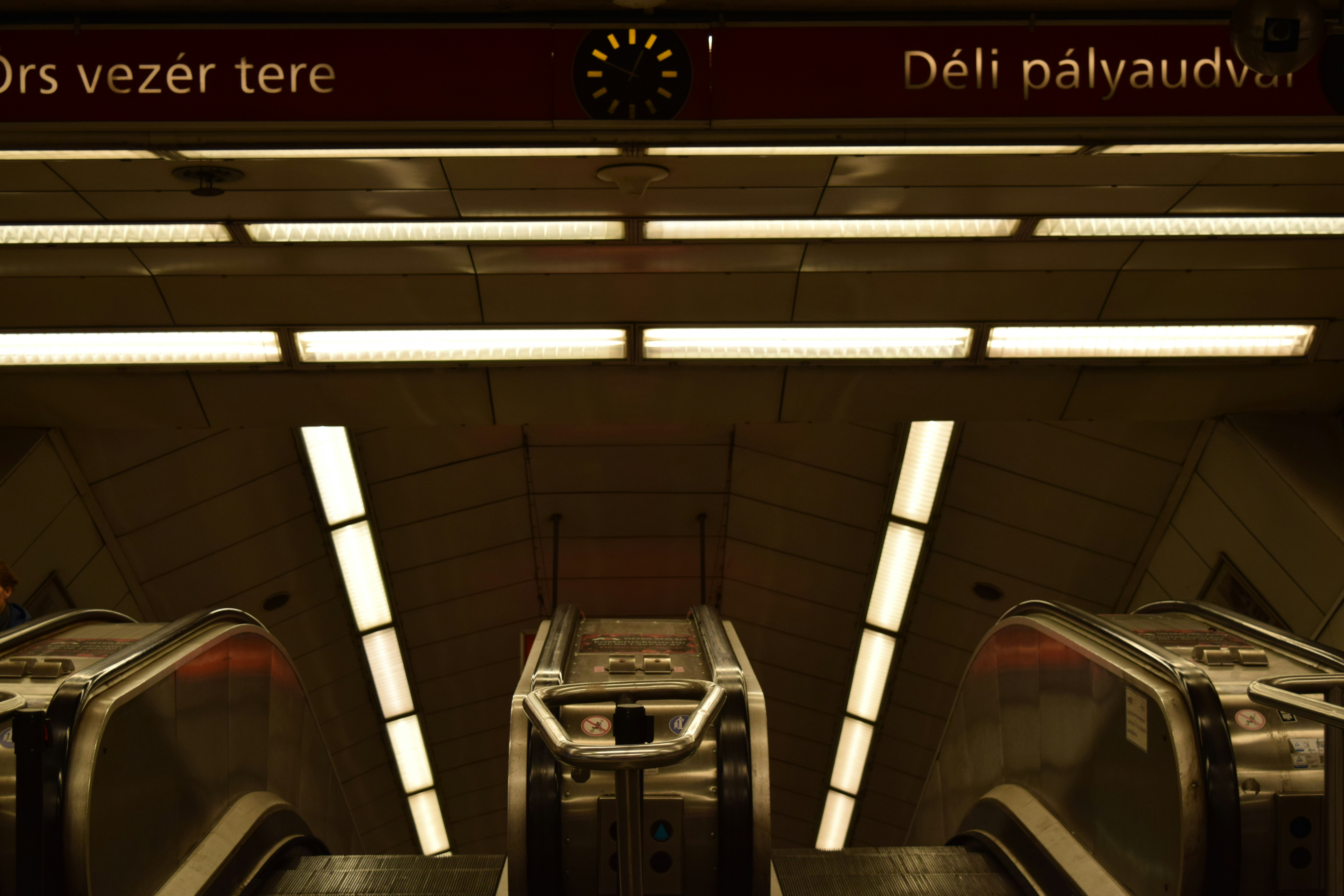 an escalator in a subway station with two escalators