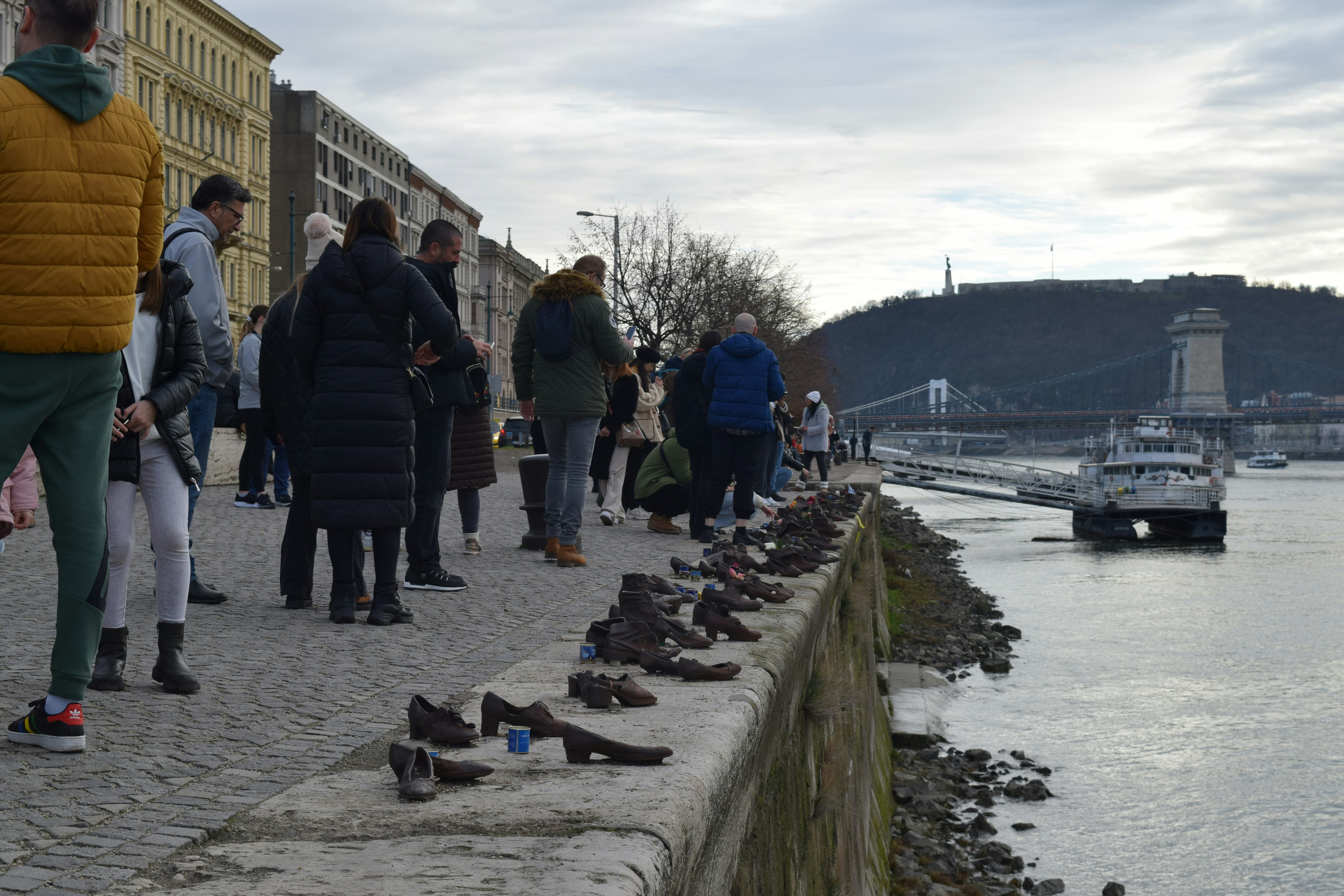 a group of people standing next to a body of water
