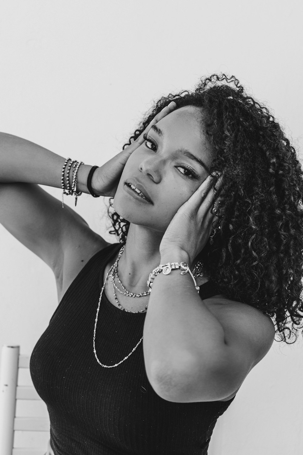 a black and white photo of a woman with curly hair