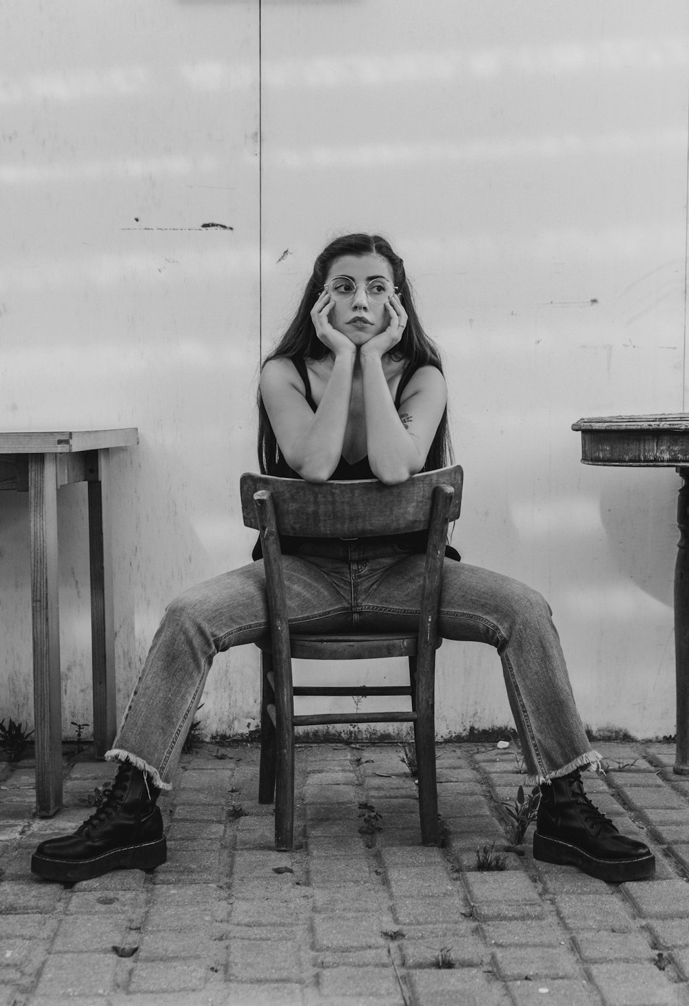 a black and white photo of a woman sitting in a chair