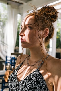 Sunlight streaming through the salon window illuminating a row of clients with diverse curly hairstyles.