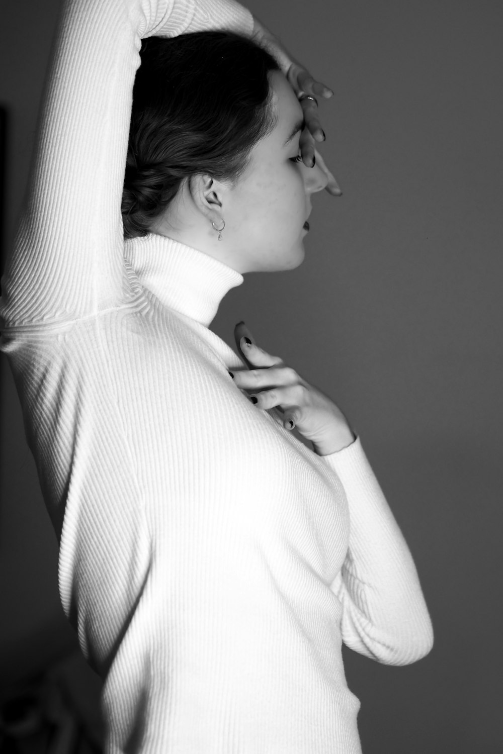 a woman in a white turtle neck sweater