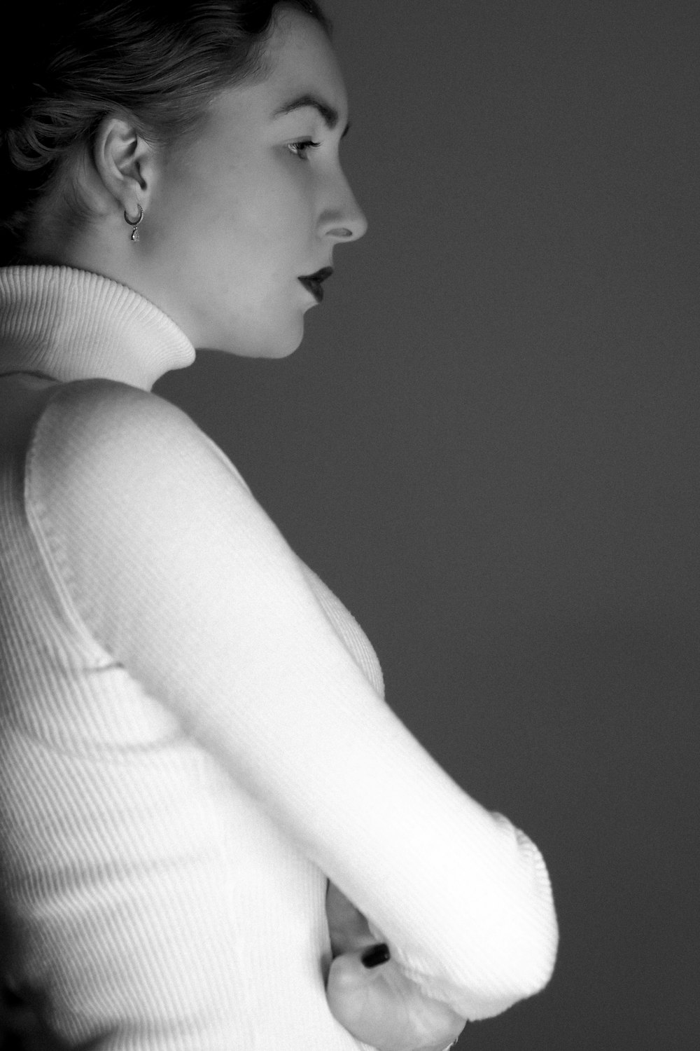 a black and white photo of a woman in a sweater