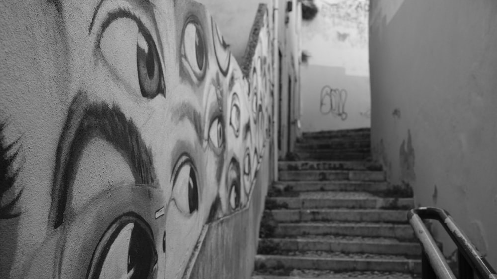 black and white photograph of a staircase with graffiti on it