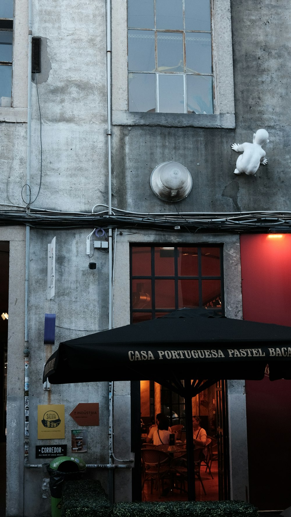 a black umbrella sitting in front of a building