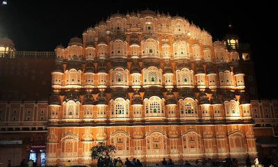 Front view of Niharika Bhawan with warm lighting at dusk.