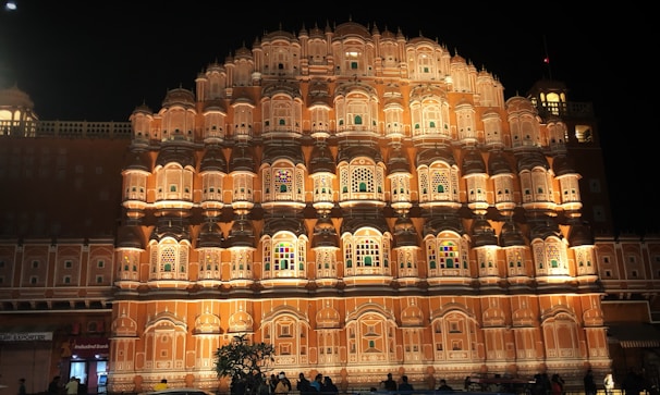Historic architecture of Sindh illuminated warmly at dusk, showcasing intricate designs.