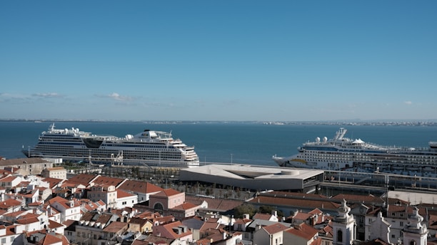 A vibrant coastal scene in Antsiranana with cruise ships docked and tourists exploring local markets.