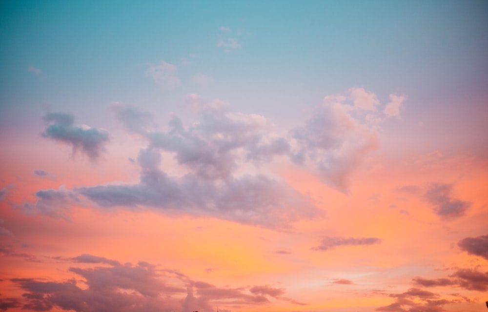 a plane is flying in the sky at sunset