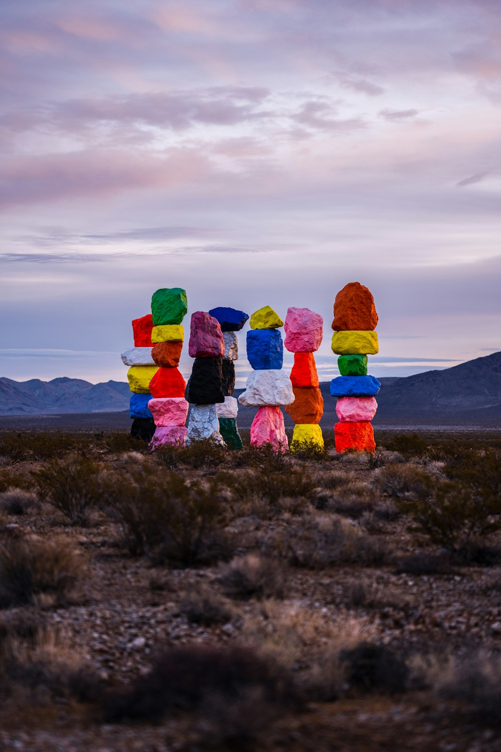 a group of people standing in the middle of a desert